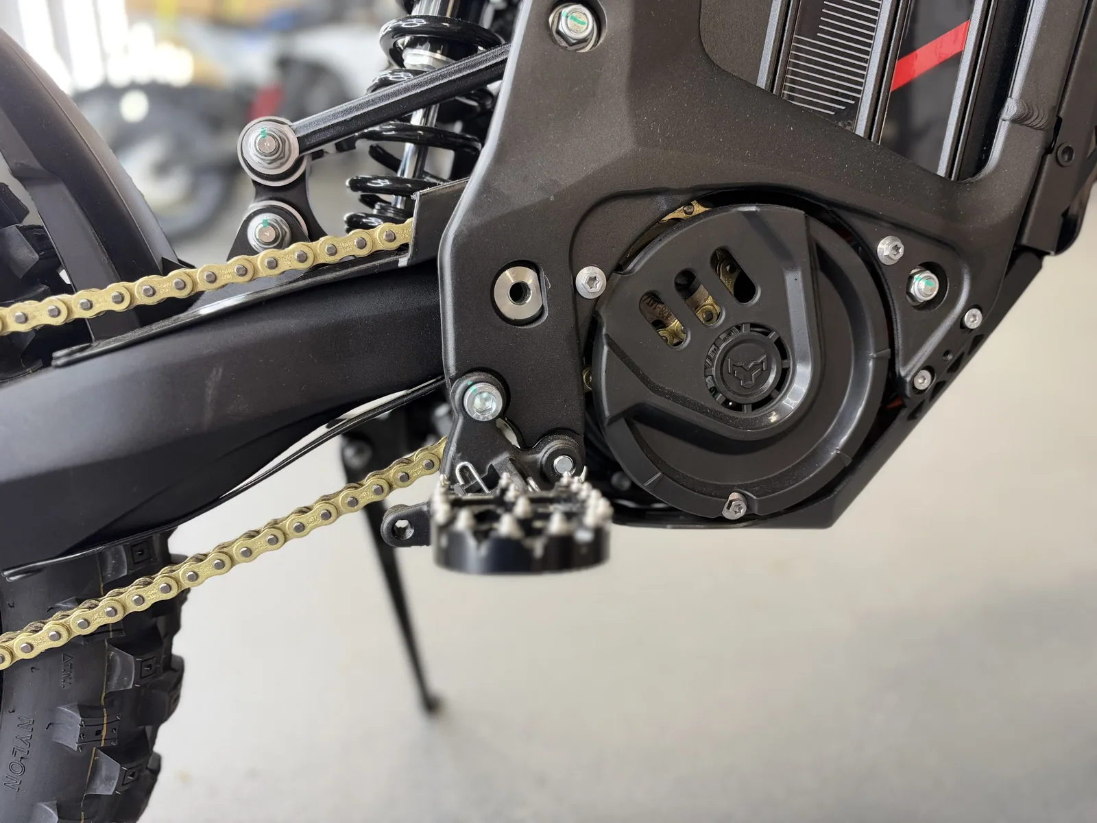 Arctic Leopard XE Pro S Enduro electric dirt bike motor and footpeg detail