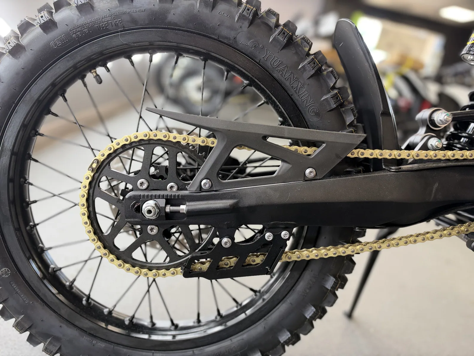 Arctic Leopard XE Pro S Enduro electric dirt bike rear wheel, chain and sprocket detail