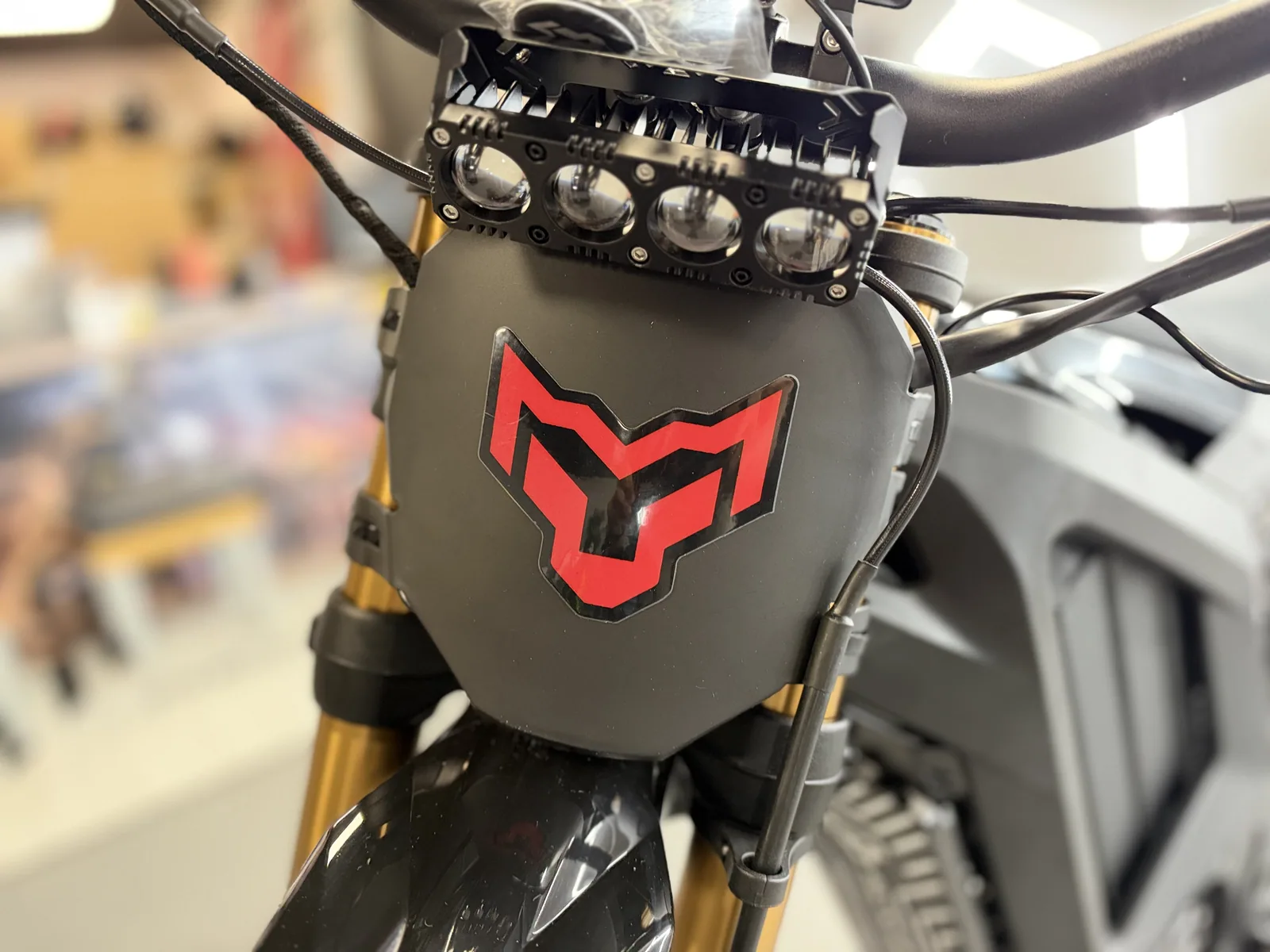 Arctic Leopard XF electric dirt bike headlight and number plate detail