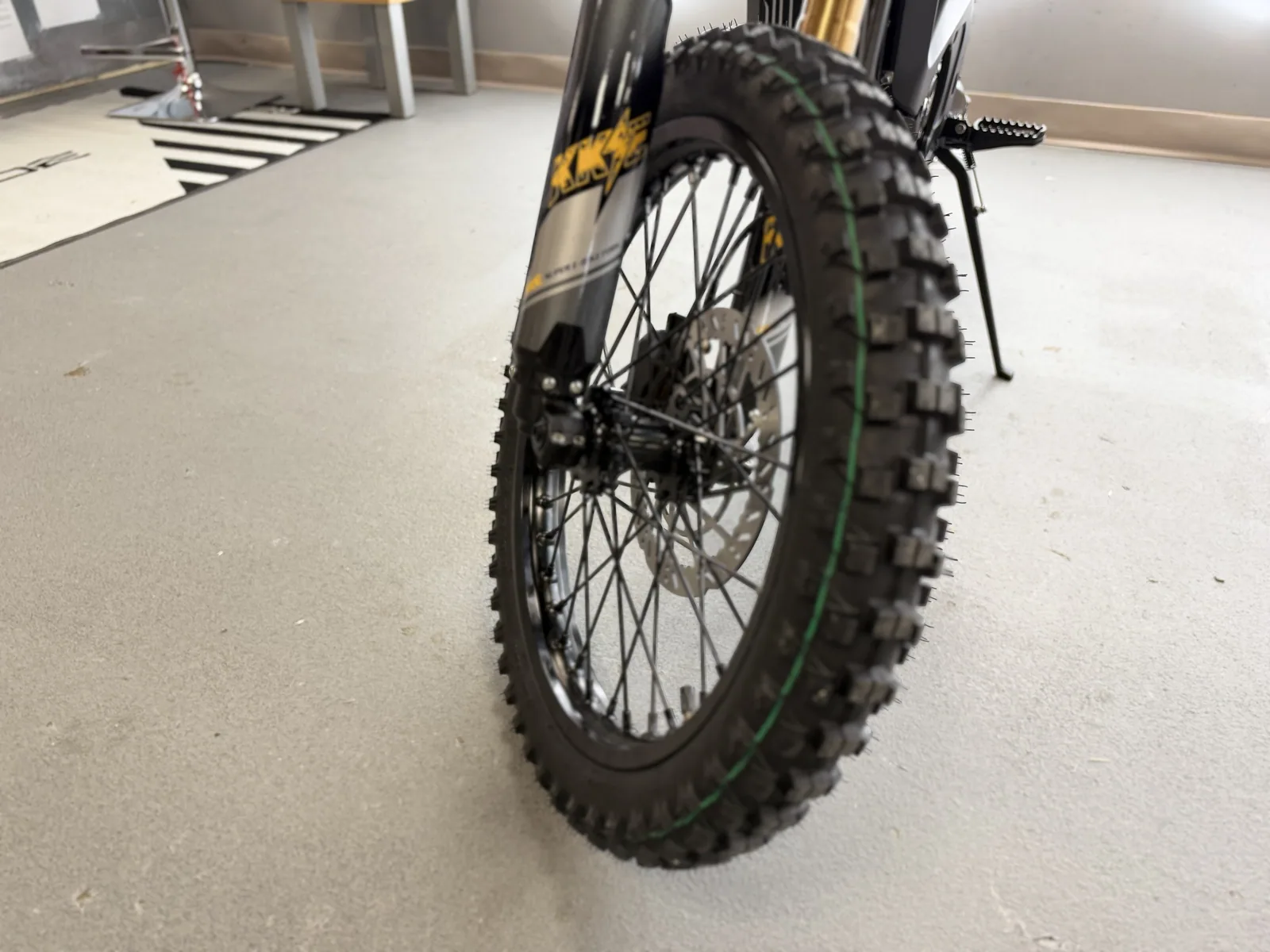 Arctic Leopard XF electric dirt bike front wheel and tire detail