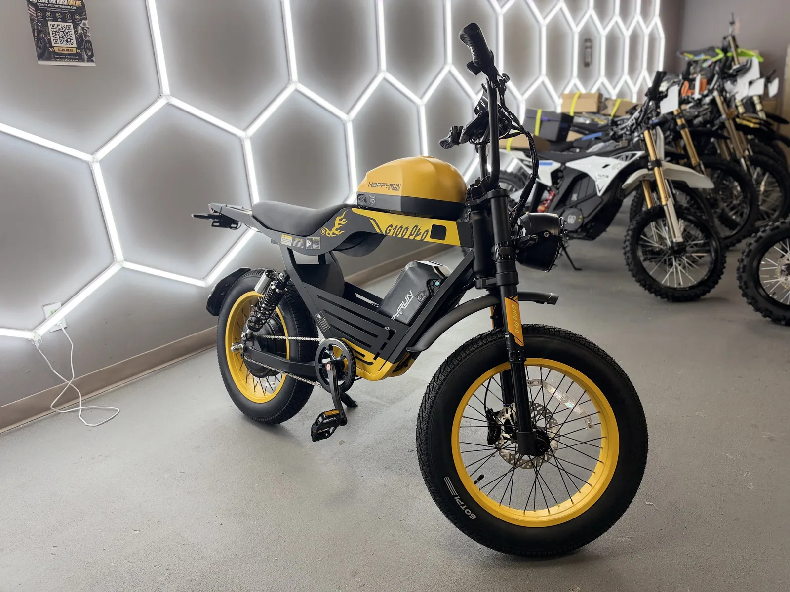 Yellow HappyRun G100 Pro electric dirt bike alternate front three-quarter view at VoltRush USA