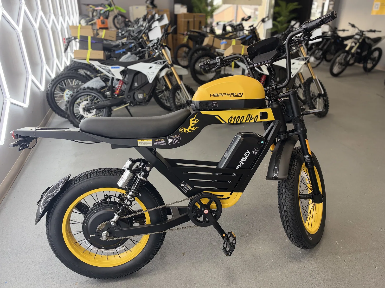 Yellow HappyRun G100 Pro electric dirt bike rear three-quarter view at VoltRush USA