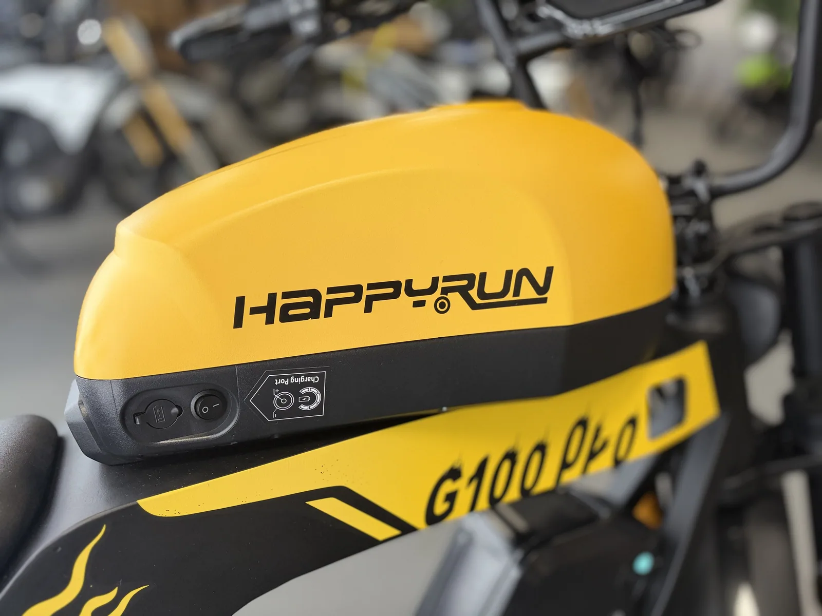Yellow HappyRun G100 Pro electric dirt bike tank detail