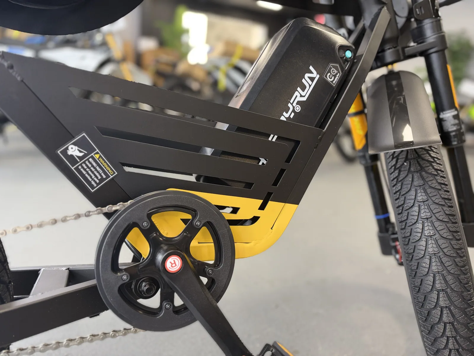 Yellow HappyRun G100 Pro electric dirt bike pedal crank and frame detail