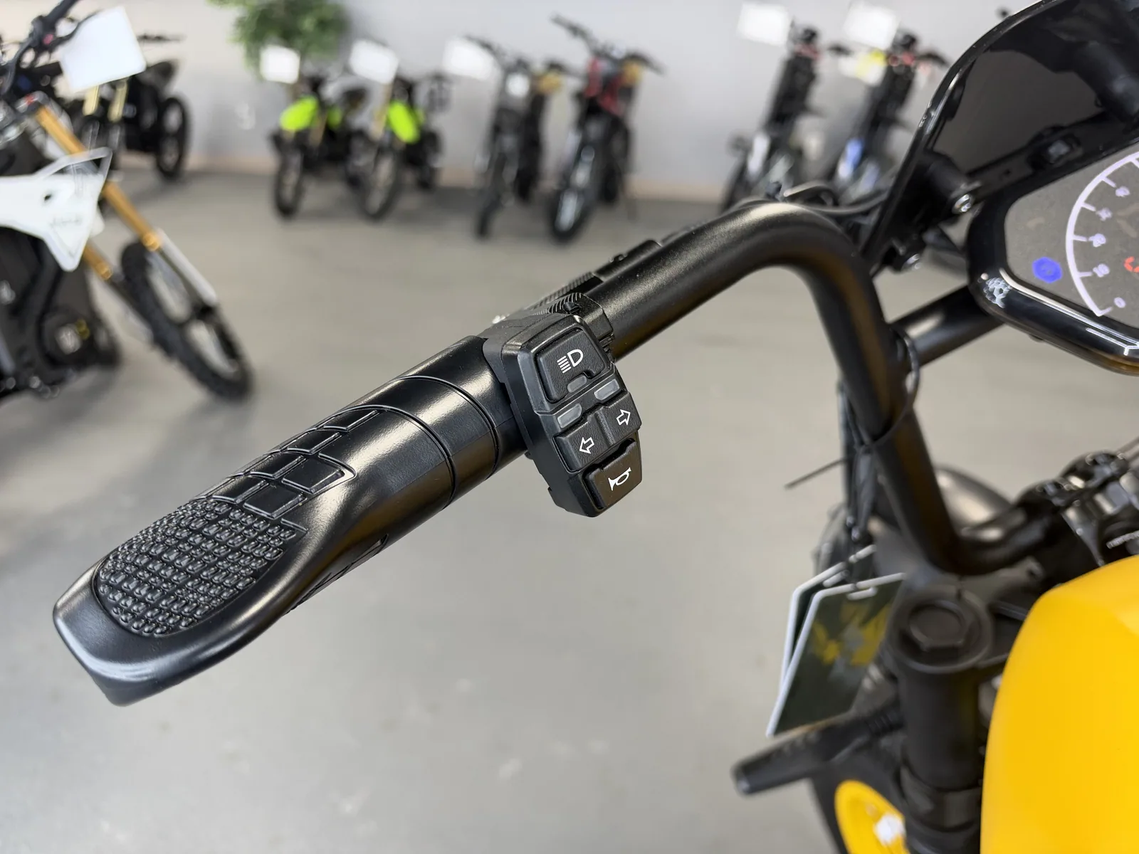Yellow HappyRun G100 Pro electric dirt bike handlebar controls detail