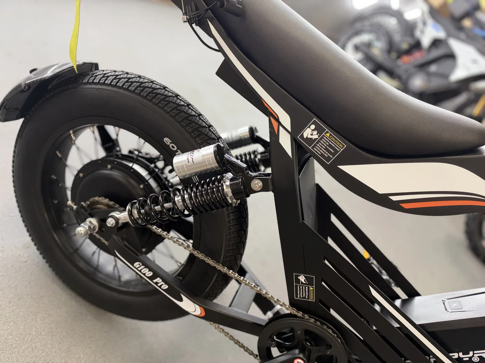 Black HappyRun G100 Pro electric dirt bike rear suspension detail