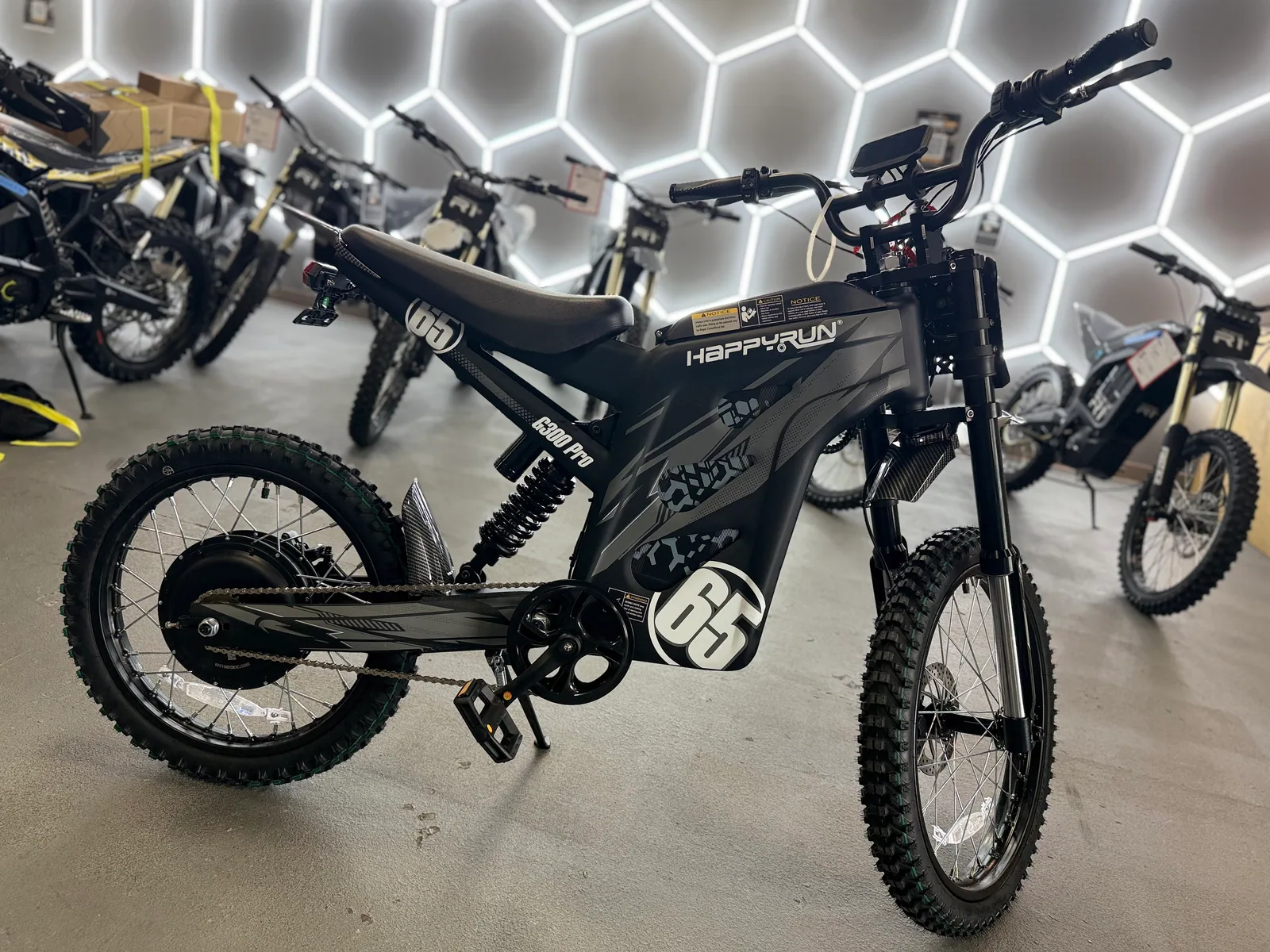 Black HappyRun G300 Pro electric dirt bike front wheel and suspension detail