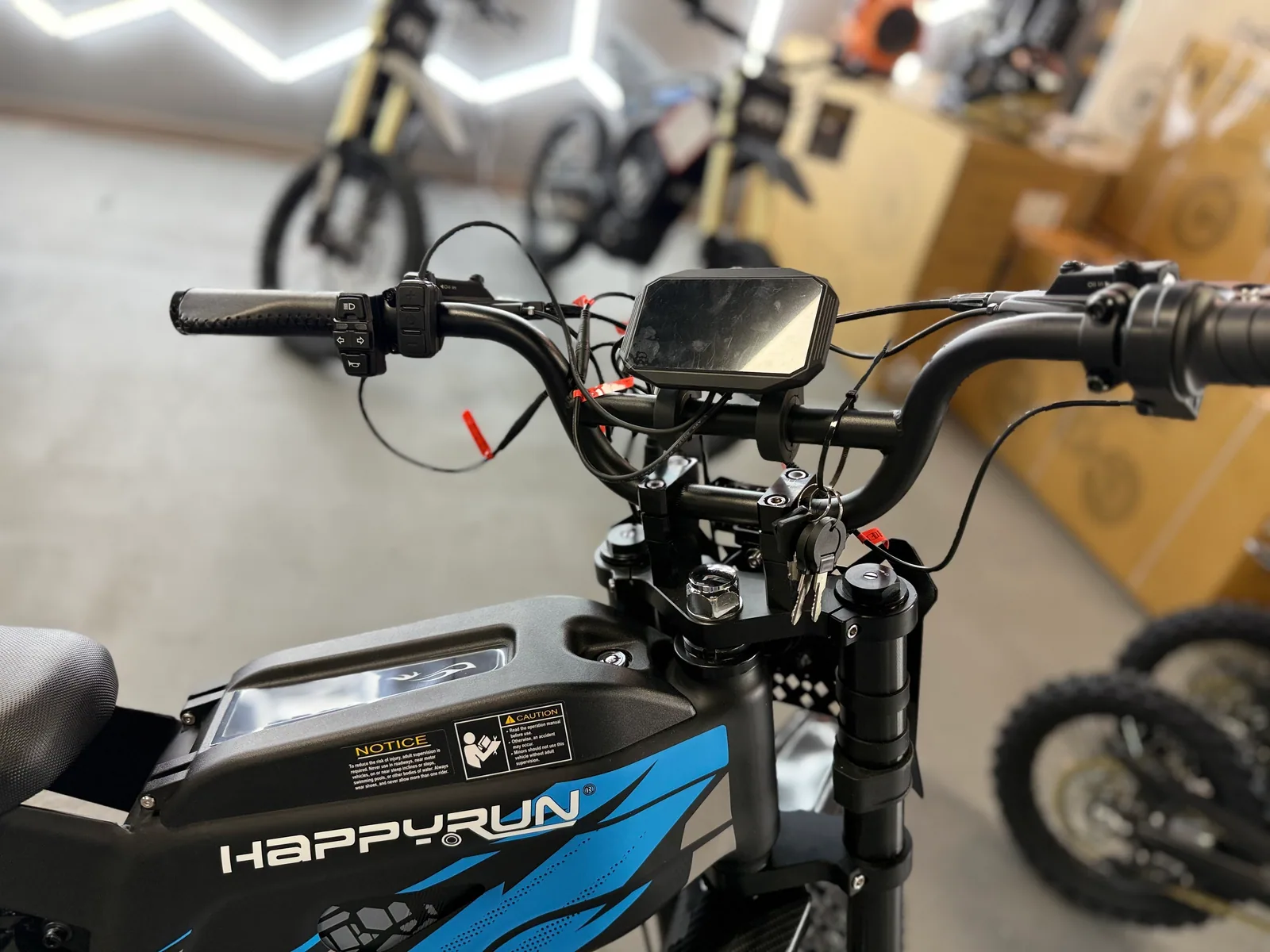 Blue HappyRun G300 Pro electric dirt bike rear three-quarter view at VoltRush USA