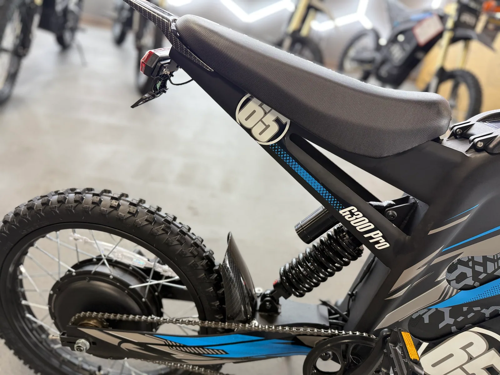 Blue HappyRun G300 Pro electric dirt bike front wheel and suspension detail