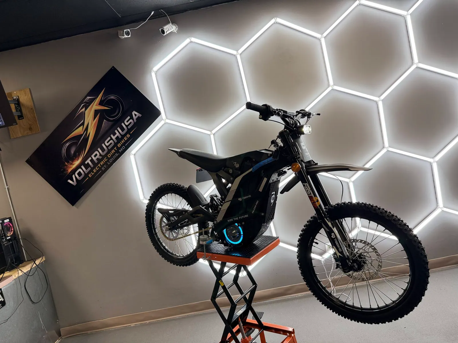 Electric dirt bike positioned on a service stand at VoltRush USA