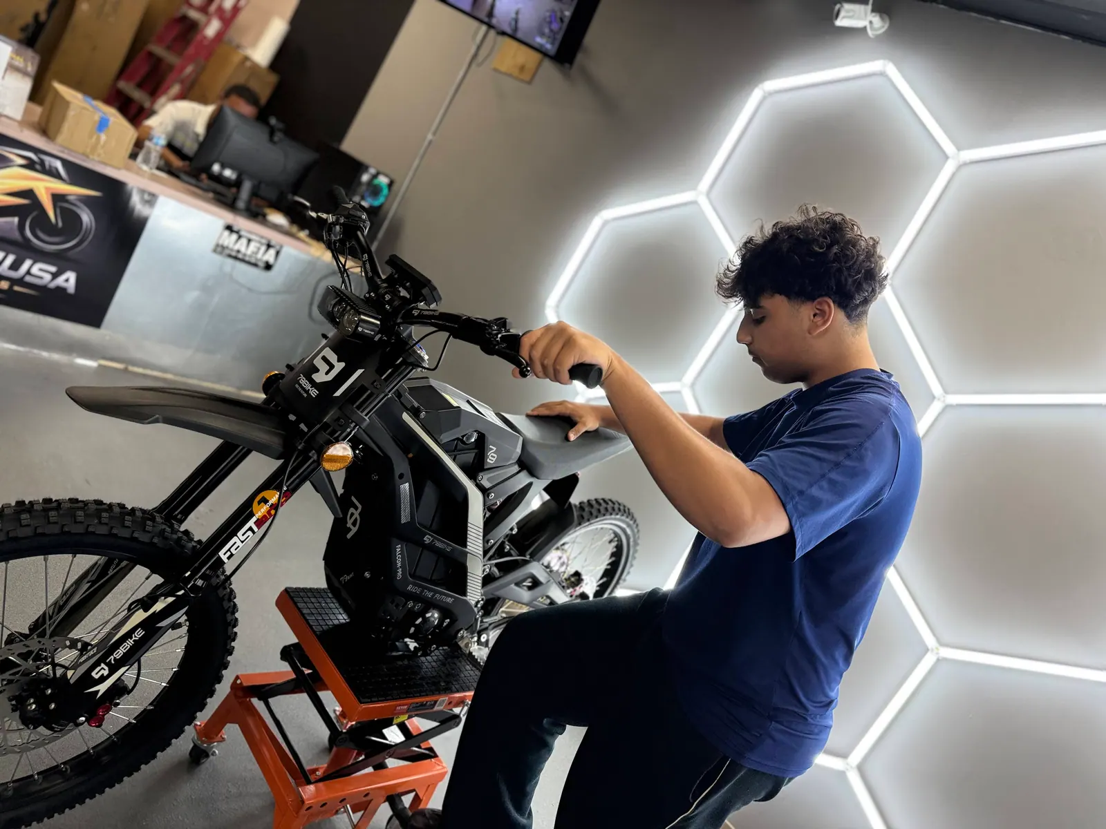 VoltRush USA team member working on an electric dirt bike setup